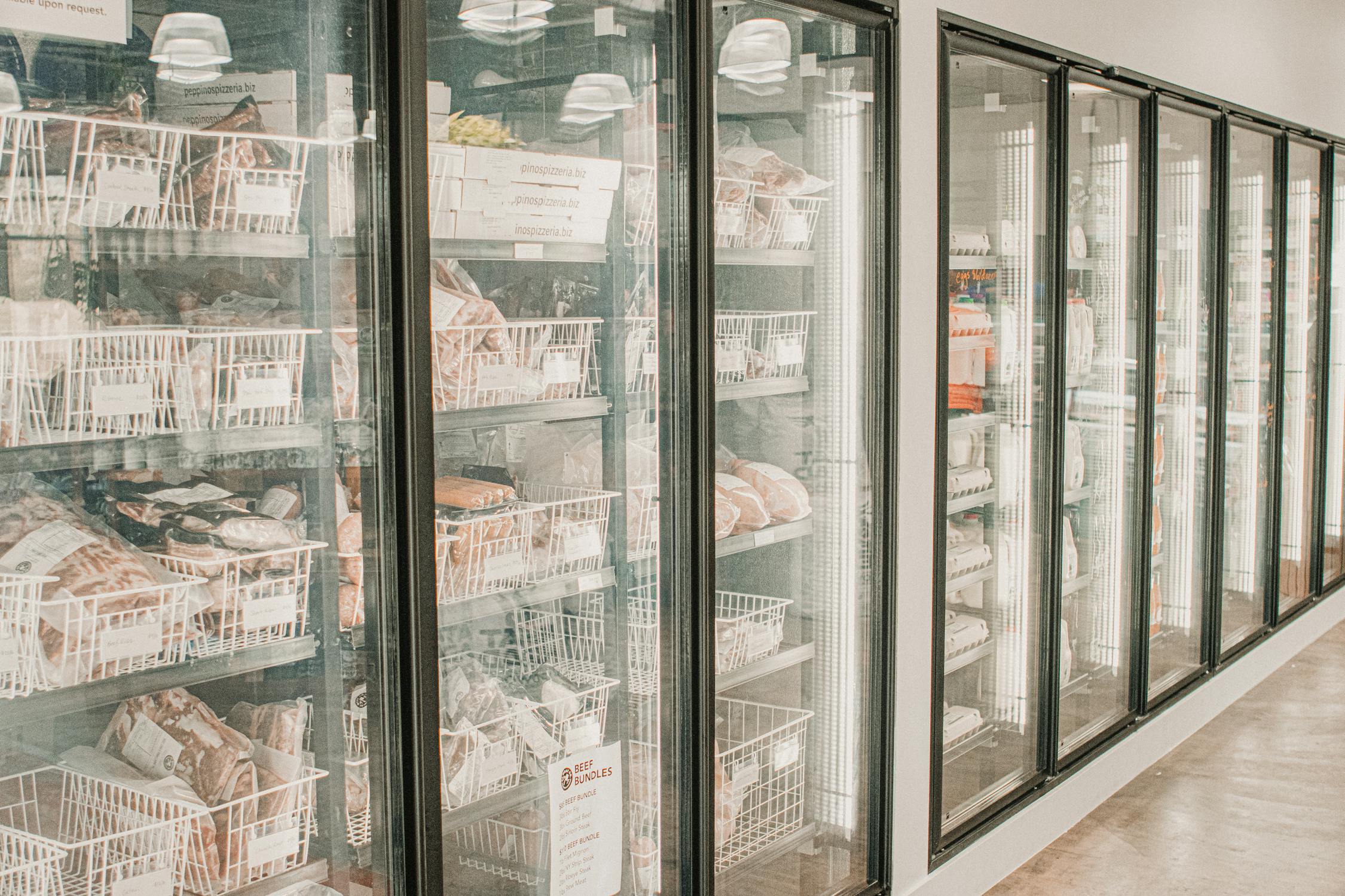 Commercial freezer display cases in a supermarket cold storage aisle